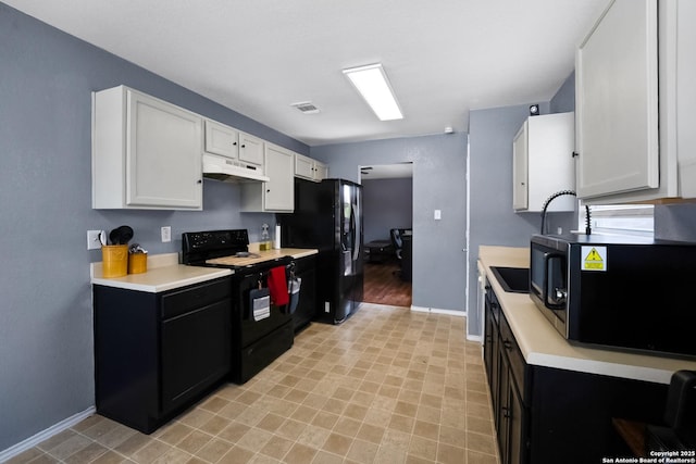 6206 Heathers Cv, San Antonio, TX 78227 - kitchen with black appliances, under cabinet range hood, light countertops, and white cabinetry