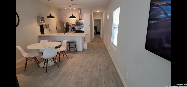 908 Camaron St, San Antonio, TX 78212 - dining room with rail lighting and light wood-style floors