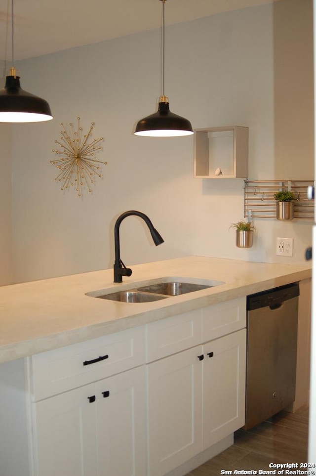 908 Camaron St, San Antonio, TX 78212 - kitchen featuring dishwasher, light countertops, white cabinets, and hanging light fixtures