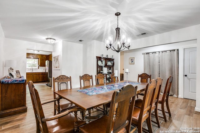 3035 Sir Phillip, San Antonio, TX 78209 - dining space with a chandelier and light wood-style flooring