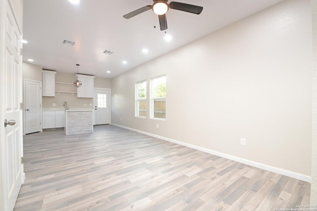 165 N San Felipe, San Antonio, TX 78237 - unfurnished living room with recessed lighting, ceiling fan, and light wood-type flooring