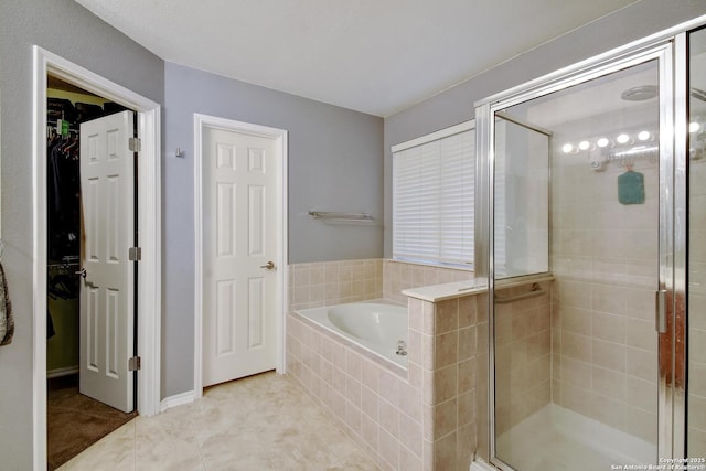 7311 Carriage, San Antonio, TX 78249 - bathroom featuring a garden tub, a shower stall, a spacious closet, and tile patterned flooring
