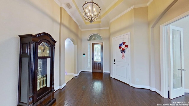 13230 Helotes, Helotes, TX 78023 - foyer entrance with a chandelier, arched walkways, crown molding, dark wood finished floors, and a towering ceiling