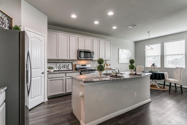 6838 Dashmoor Crk, San Antonio, TX 78244 - kitchen with stainless steel appliances, recessed lighting, dark wood-style floors, light stone countertops, and backsplash