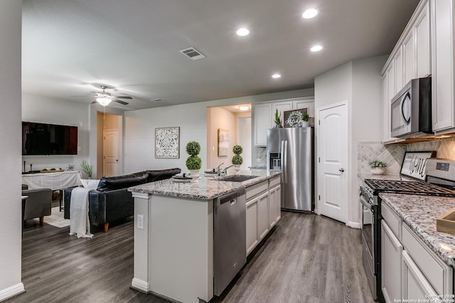 6838 Dashmoor Crk, San Antonio, TX 78244 - kitchen featuring appliances with stainless steel finishes, dark wood-style flooring, open floor plan, ceiling fan, and white cabinets