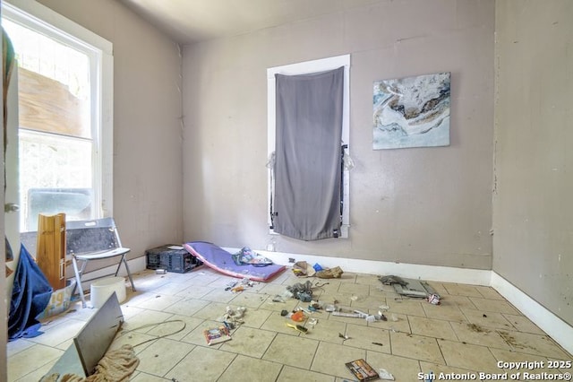 310 E Carson, San Antonio, TX 78208 - unfurnished bedroom with multiple windows and tile patterned floors