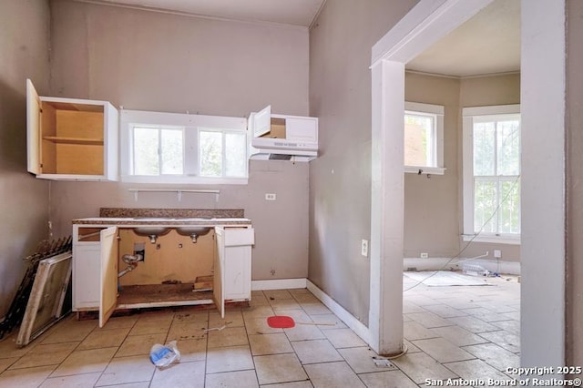310 E Carson, San Antonio, TX 78208 - kitchen featuring white cabinetry, ornamental molding, open shelves, and light tile patterned flooring