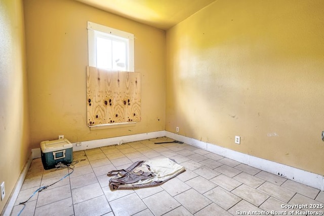 310 E Carson, San Antonio, TX 78208 - tiled empty room featuring baseboards