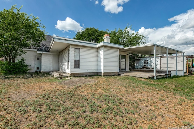 810 Cobble, San Antonio, TX 78216 - rear view of property featuring an attached carport, a yard, and a chimney