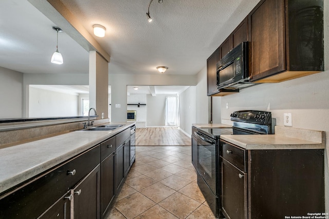 810 Cobble, San Antonio, TX 78216 - kitchen with black appliances, light tile patterned floors, dark brown cabinetry, light countertops, and a textured ceiling
