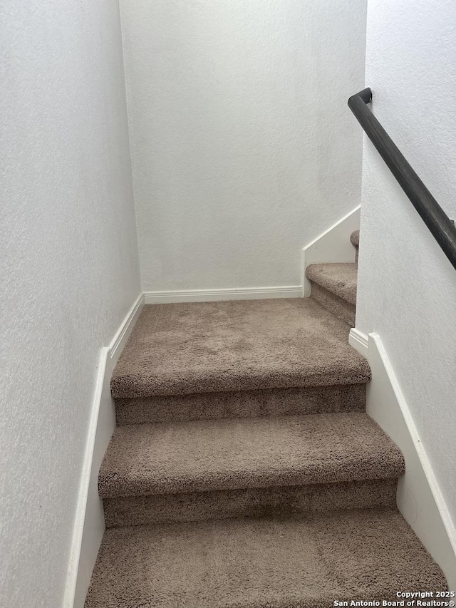 6135 Lakefront, San Antonio, TX 78222 - stairs featuring a textured wall and carpet flooring