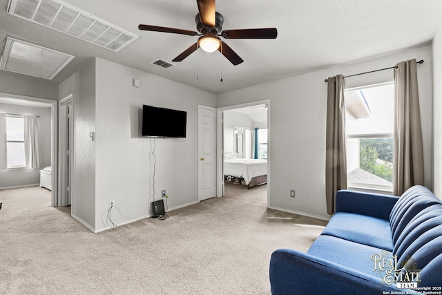 6027 Still Mdw, San Antonio, TX 78222 - living room featuring attic access, carpet flooring, and a ceiling fan