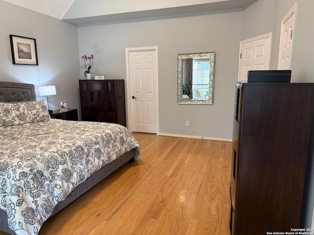 13011 Vidorra Vis, San Antonio, TX 78216 - bedroom featuring light wood-style floors, refrigerator, and lofted ceiling