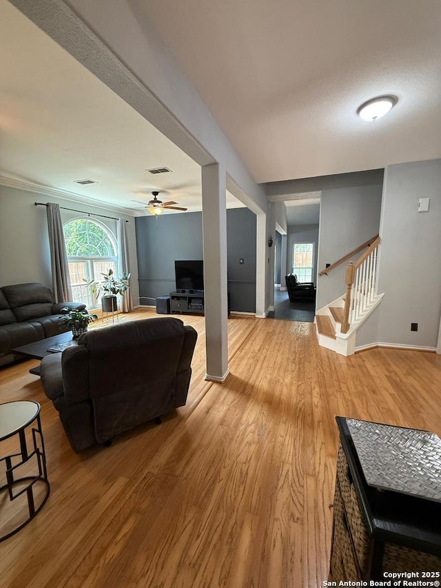 13011 Vidorra Vis, San Antonio, TX 78216 - living area with wood finished floors, plenty of natural light, ceiling fan, and stairs