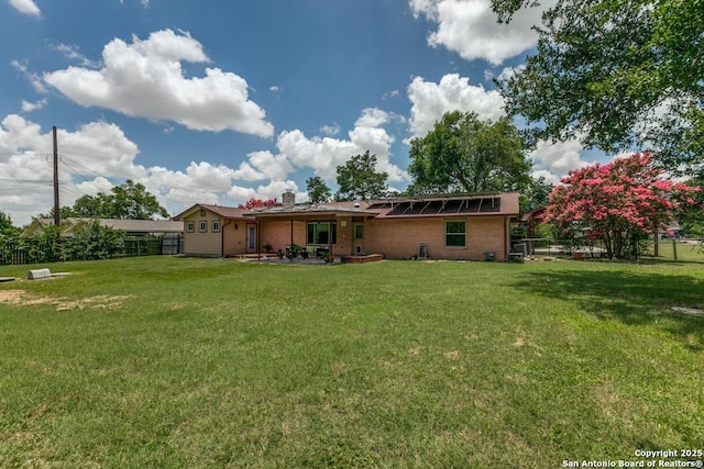 10615 Bar X Trl, San Antonio, TX 78023 - rear view of house featuring a fenced backyard, a chimney, brick siding, and a patio