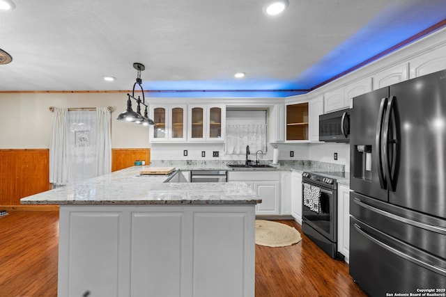 6033 Cammie, Leon Valley, TX 78238 - kitchen featuring stainless steel appliances, a wainscoted wall, white cabinetry, glass insert cabinets, and dark wood-type flooring
