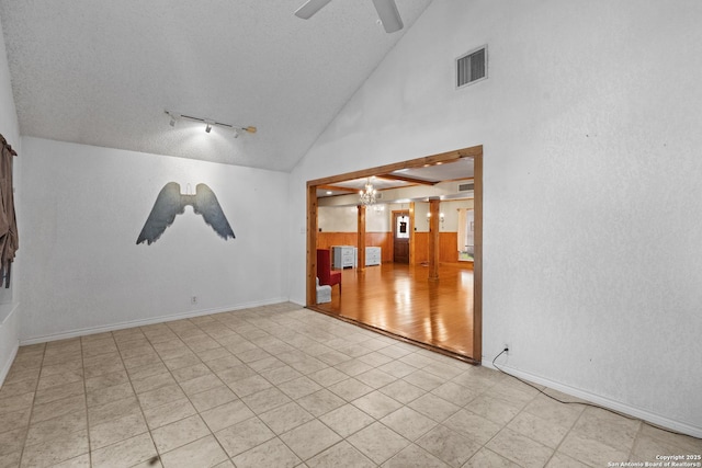 6033 Cammie, Leon Valley, TX 78238 - empty room featuring rail lighting, ceiling fan, and vaulted ceiling