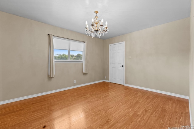 6033 Cammie, Leon Valley, TX 78238 - empty room with a chandelier and wood finished floors