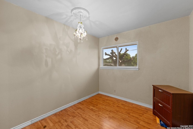6033 Cammie, Leon Valley, TX 78238 - spare room featuring a chandelier and light wood-style floors
