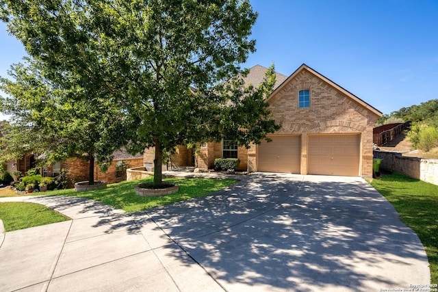 8603 Artesia Gap, Helotes, TX 78023 - view of front facade featuring driveway, brick siding, an attached garage, and a front lawn