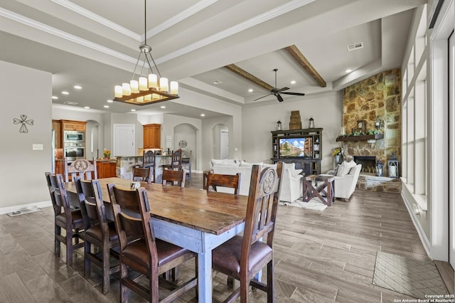 1117 Provence Pl, New Braunfels, TX 78132 - dining area featuring a ceiling fan, arched walkways, recessed lighting, a stone fireplace, and ornamental molding