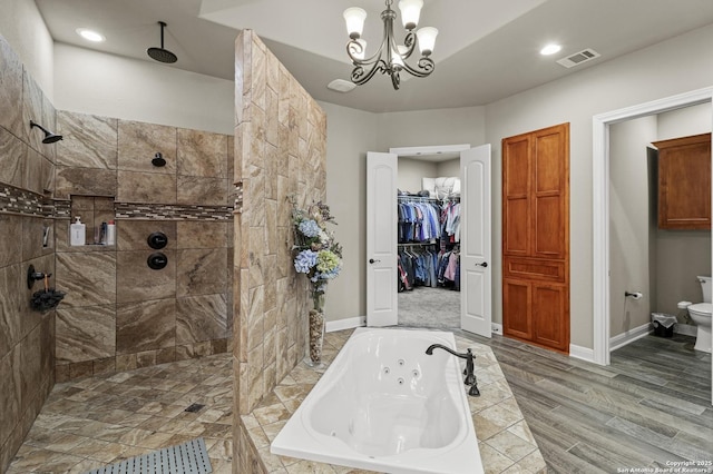 1117 Provence Pl, New Braunfels, TX 78132 - bathroom with a tub with jets, a walk in shower, wood finished floors, a chandelier, and recessed lighting