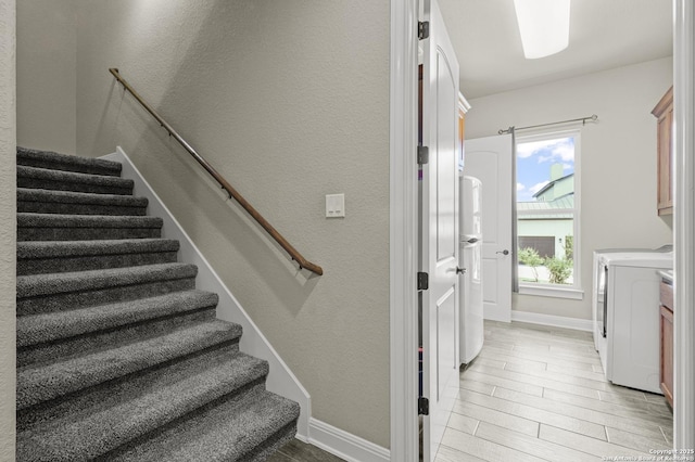 1117 Provence Pl, New Braunfels, TX 78132 - stairway with washer and dryer, wood finished floors, and a textured wall