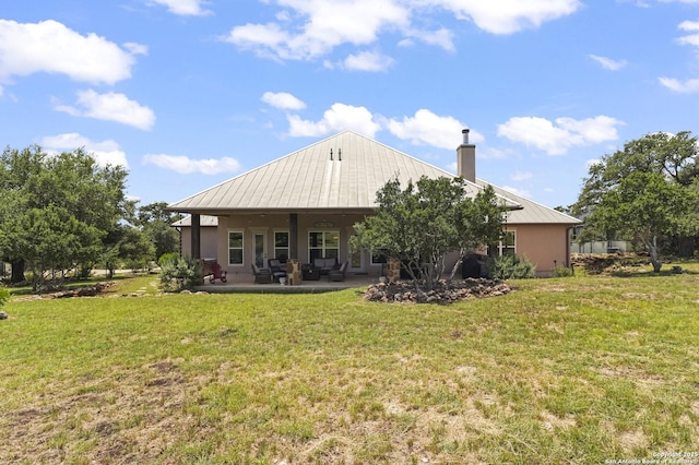 1117 Provence Pl, New Braunfels, TX 78132 - back of house featuring a metal roof, a lawn, a chimney, and stucco siding