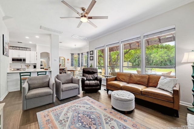 15315 Flying Cir, San Antonio, TX 78023 - living area with ornamental molding, wood finished floors, a ceiling fan, recessed lighting, and arched walkways