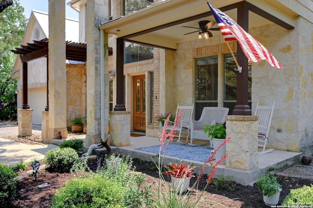15315 Flying Cir, San Antonio, TX 78023 - doorway to property with stone siding, ceiling fan, and covered porch