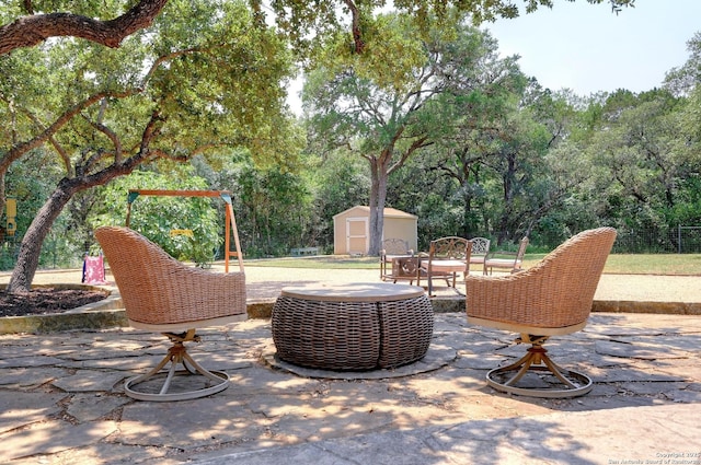 15315 Flying Cir, San Antonio, TX 78023 - view of patio featuring a storage unit and view of wooded area