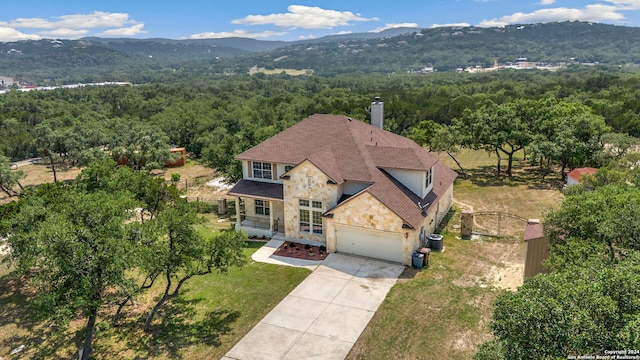 17132 Bandera Rd, Helotes, TX 78023 - aerial view of property and surrounding area featuring a heavily wooded area and a mountain backdrop