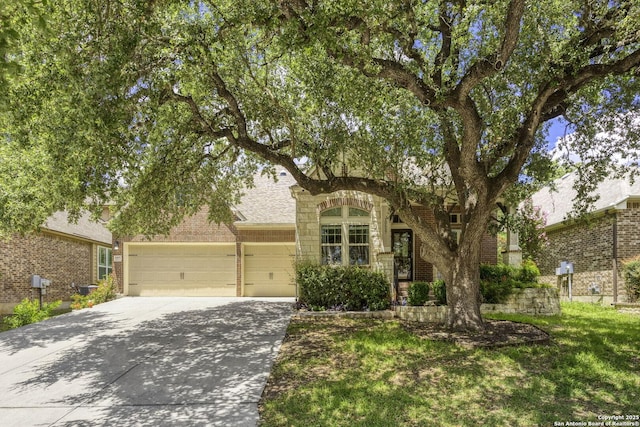 10657 Foxen Way, Helotes, TX 78023 - view of front facade featuring concrete driveway, an attached garage, and brick siding