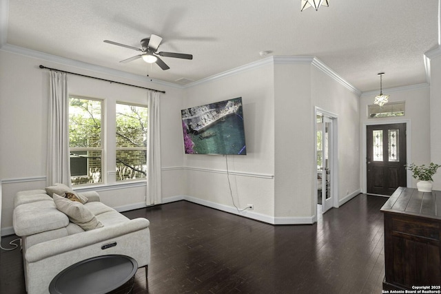 10657 Foxen Way, Helotes, TX 78023 - living area featuring a ceiling fan, dark wood-style floors, and ornamental molding