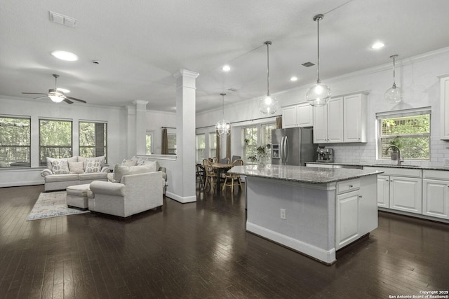 10657 Foxen Way, Helotes, TX 78023 - kitchen with stainless steel refrigerator with ice dispenser, a ceiling fan, dark wood-style flooring, a kitchen island, and recessed lighting