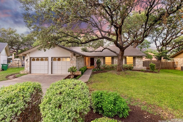 14310 Fox Fire Ln, San Antonio, TX 78231 - ranch-style house with stone siding, concrete driveway, and a garage
