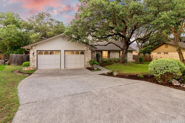 14310 Fox Fire Ln, San Antonio, TX 78231 - view of front of house featuring stone siding, concrete driveway, and an attached garage