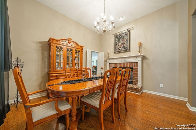 26304 Tiffnilee, San Antonio, TX 78255 - dining room with a chandelier, wood finished floors, and a fireplace