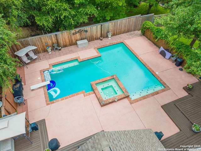 26304 Tiffnilee, San Antonio, TX 78255 - view of pool with a pool with connected hot tub, a fenced backyard, and a patio