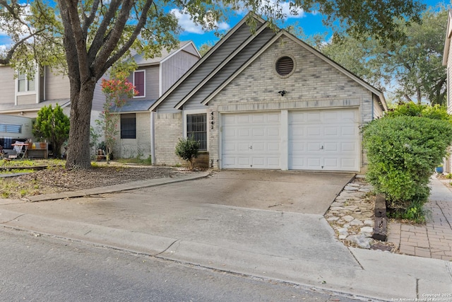4242 Shady Tree Ln, San Antonio, TX 78247 - traditional-style house with an attached garage, brick siding, and driveway