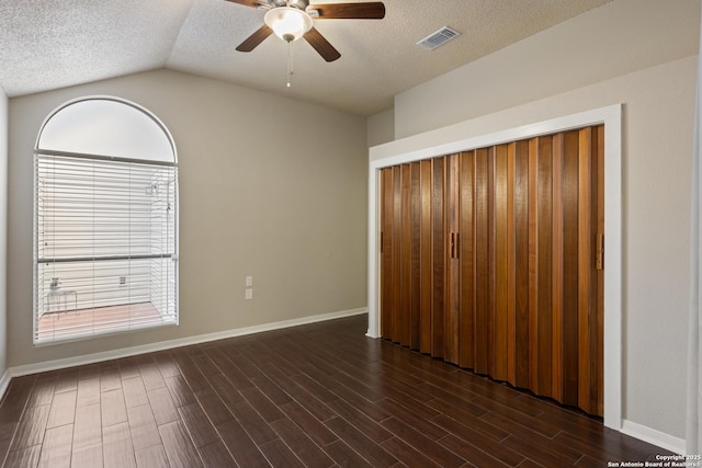 4242 Shady Tree Ln, San Antonio, TX 78247 - unfurnished bedroom featuring a textured ceiling, dark wood-style flooring, vaulted ceiling, a ceiling fan, and a closet