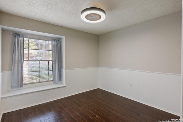 4242 Shady Tree Ln, San Antonio, TX 78247 - unfurnished room featuring wood finished floors, wainscoting, and a textured ceiling