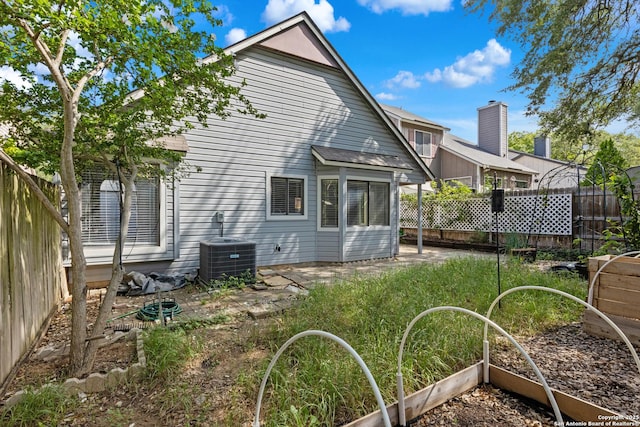 4242 Shady Tree Ln, San Antonio, TX 78247 - rear view of house with a vegetable garden