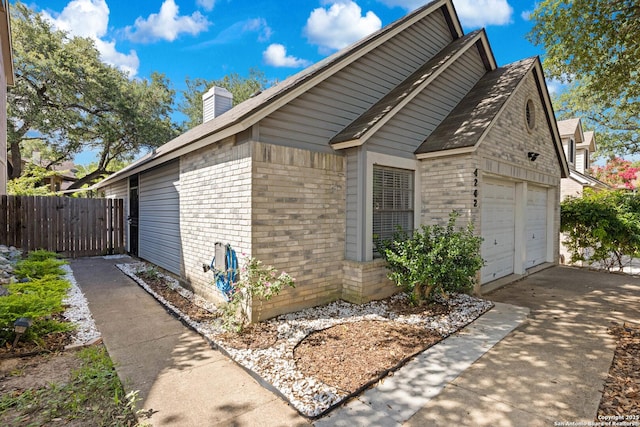 4242 Shady Tree Ln, San Antonio, TX 78247 - view of property exterior with brick siding, a chimney, and roof with shingles
