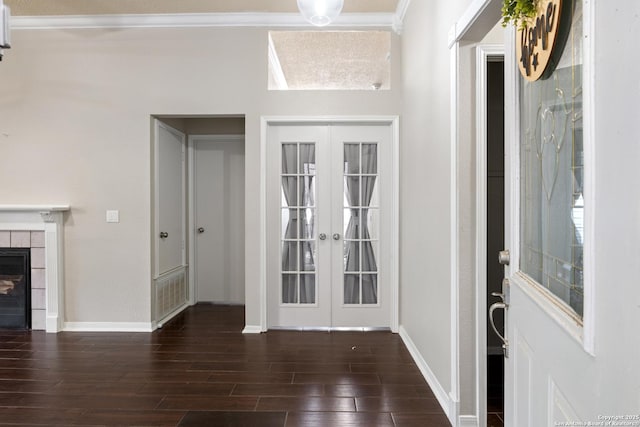 4242 Shady Tree Ln, San Antonio, TX 78247 - entryway with wood finished floors, crown molding, french doors, and a tiled fireplace