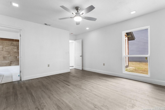 5530 Rangeland, San Antonio, TX 78247 - unfurnished bedroom featuring wood finished floors, ceiling fan, and ensuite bath