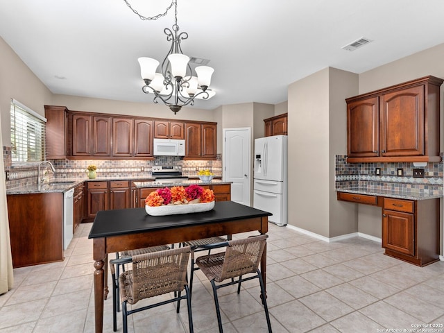 5 Greta Dr, San Antonio, TX 78248 - kitchen with white appliances, tasteful backsplash, a chandelier, and light tile patterned floors
