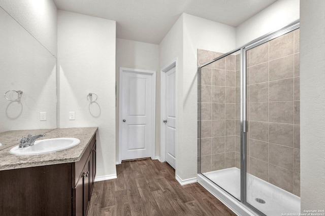 14016 Breccia Loop, San Antonio, TX 78253 - full bathroom featuring vanity, wood finished floors, and a shower stall