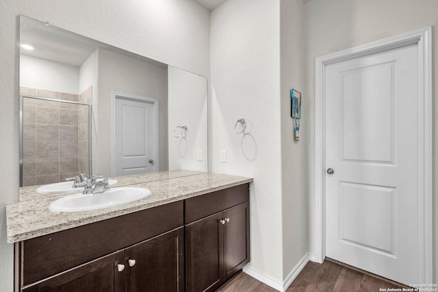 14016 Breccia Loop, San Antonio, TX 78253 - bathroom featuring vanity, wood finished floors, and a tile shower