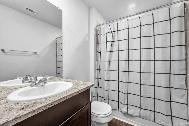 14016 Breccia Loop, San Antonio, TX 78253 - full bath with vanity, wood finished floors, a textured wall, and shower / bath combo with shower curtain